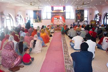 Congregation inside a Sikh Gurdwara